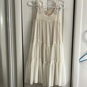 Elegant Cream Sleeveless Dress with Floral Accents